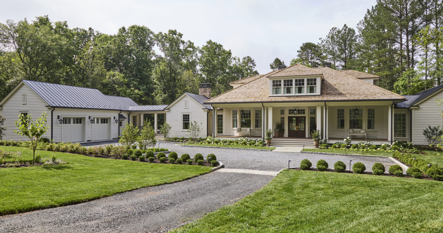 The front arrival court or parking area of the Southern Living Idea House with surrounding plants