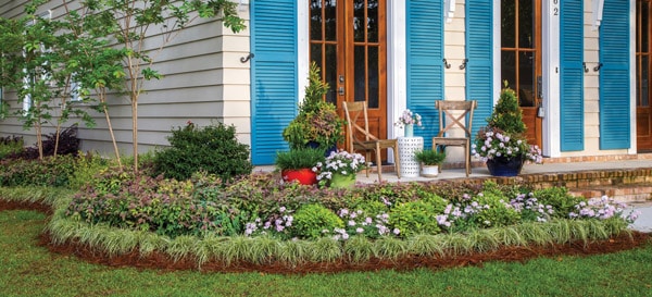 Front porch lined with numerous different beautiful Southern Living Plants
