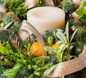 Wreath of evergreen limbs with a center candle