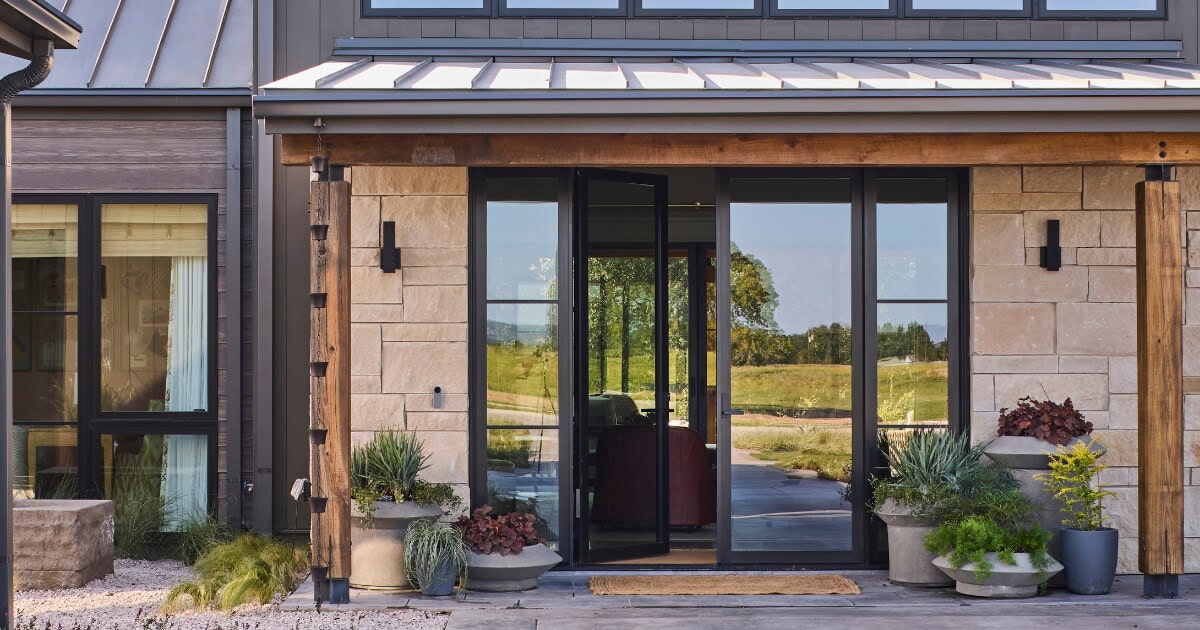 Container plantings bring foliage and texture to the front porch of the Southern Living Idea House